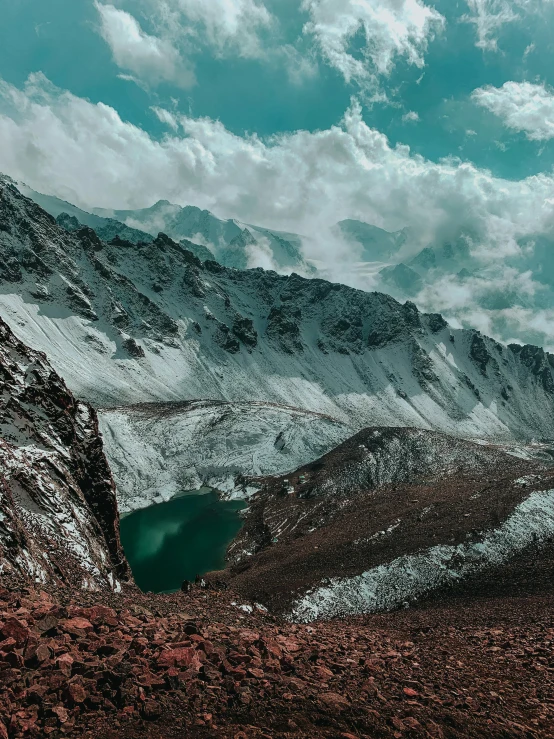 a man standing on a cliff near a body of water