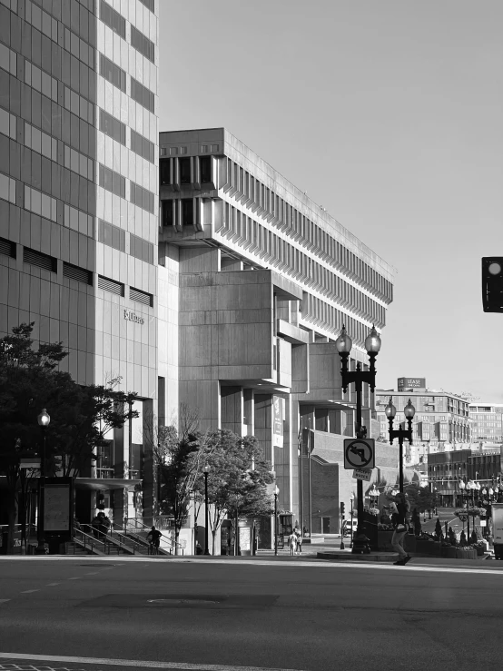 people and cars moving across an intersection on the road