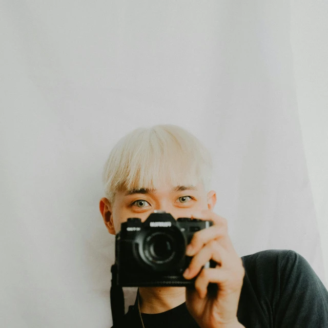 a man holding a camera up to his face