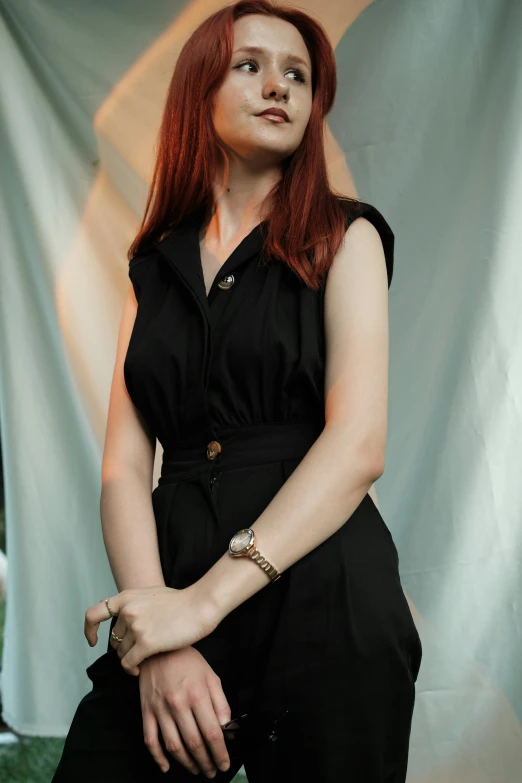 a woman with red hair posing for a po