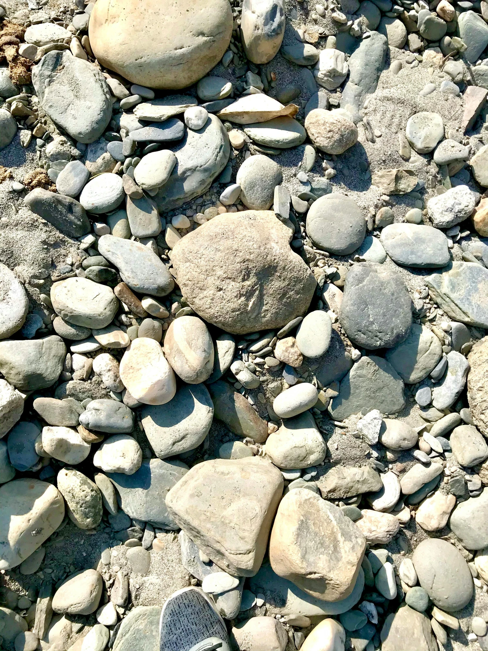 several rocks lay on a large rock