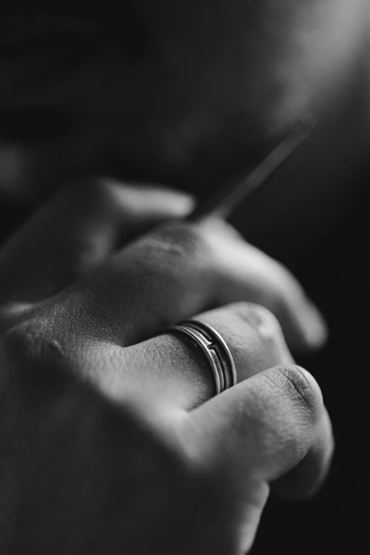an image of a person holding a wedding ring