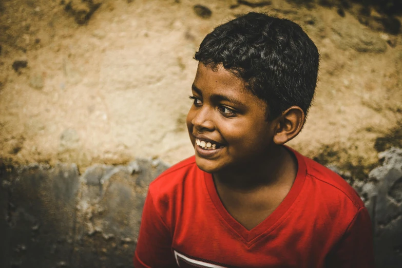 the young child smiles and poses for the camera