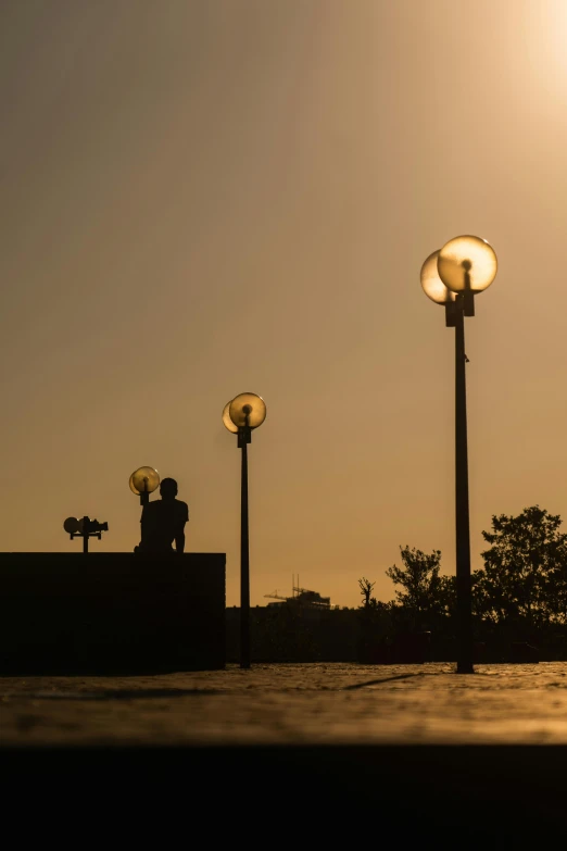 two street lights sitting on top of a cement block