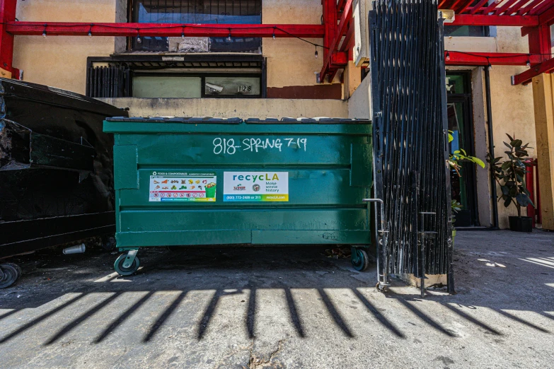 green box sitting in front of some buildings