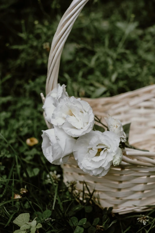 there is a white basket that has flowers inside of it
