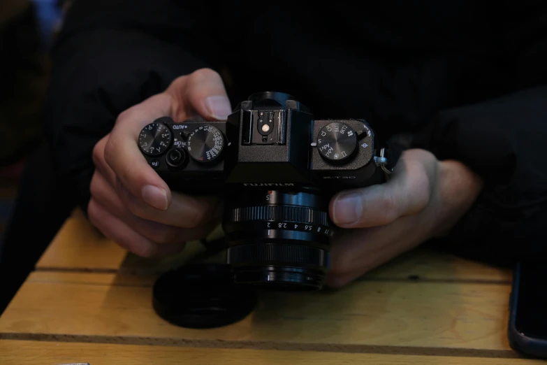 a man holding an old camera in both hands