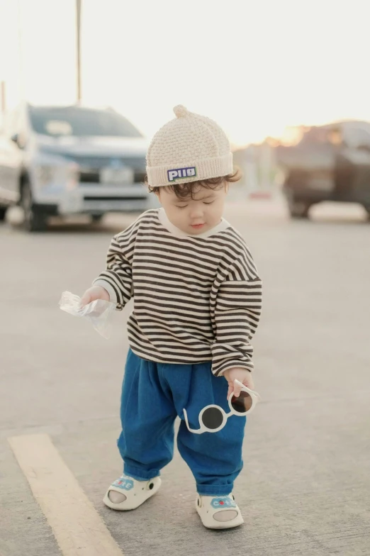 a baby boy that is standing in the street