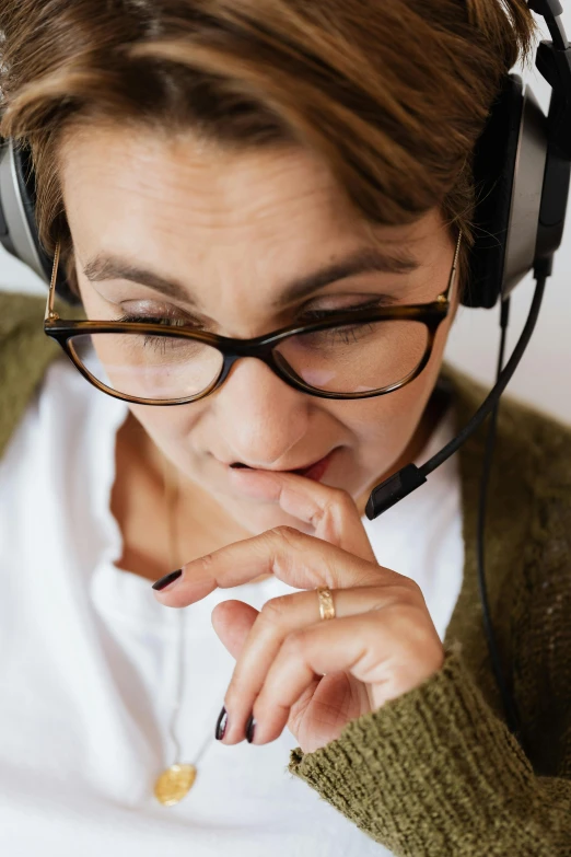 a woman with headphones on looking at her watch