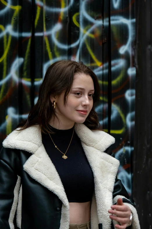 a woman in black shirt with white jacket