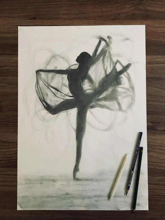 an ink drawing of a ballerina on paper and crayons