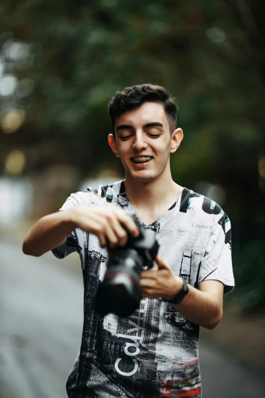 man holding up camera taking po on the street