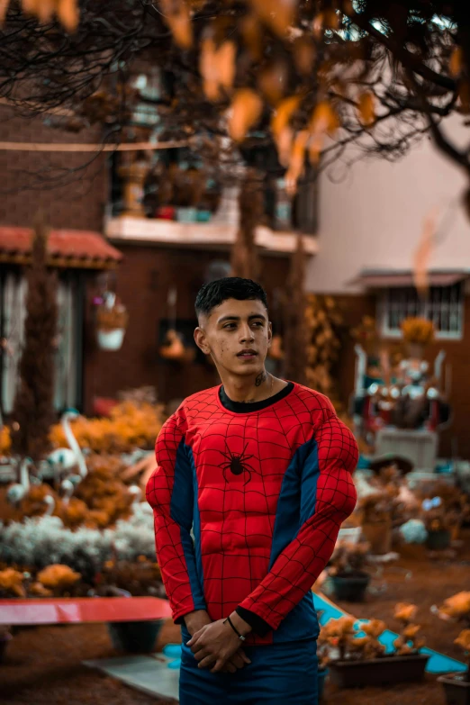 man in a red and blue jacket looking into camera