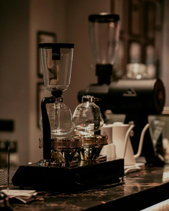 a coffee pot and glass on a counter