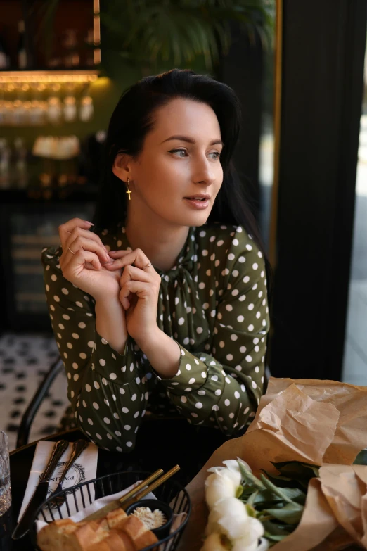 the woman is eating a pizza on her hand