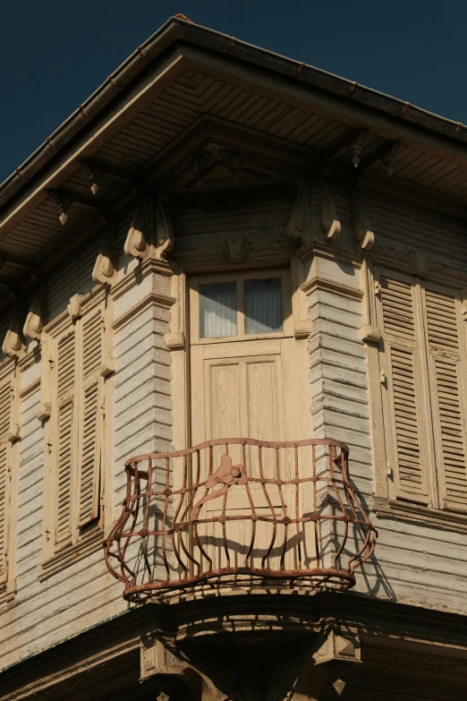 an old balcony with shutters and windows
