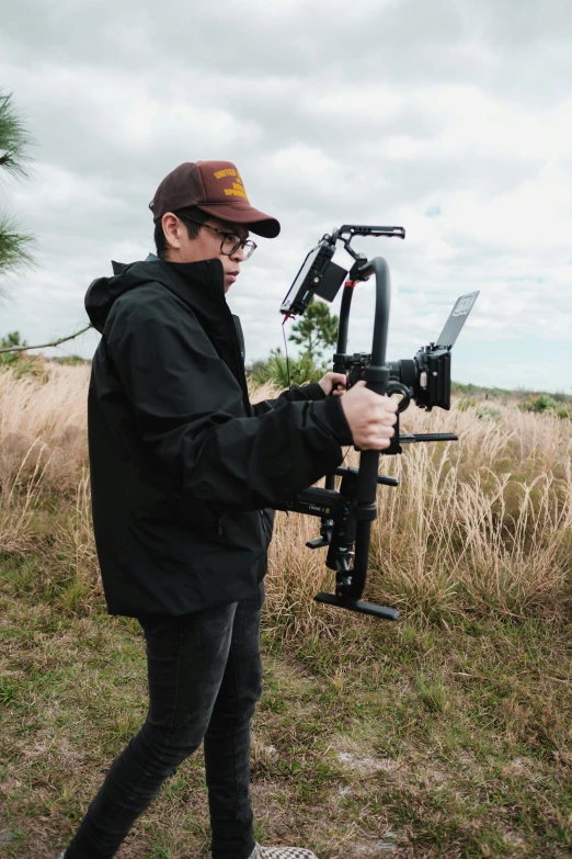 a man is holding up an upside down camera rig