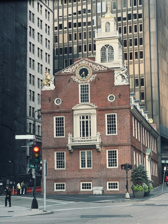 the building is red brick with a large clock tower