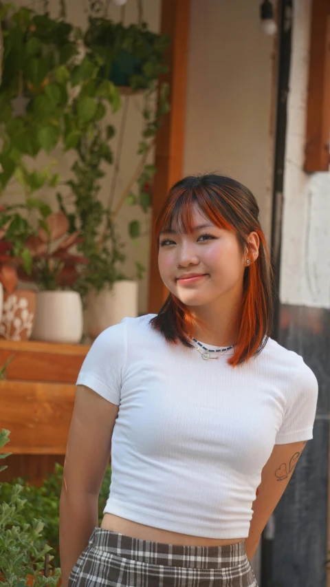 a young woman standing and posing for the camera