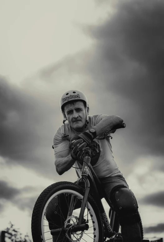 a man riding on top of a bike with a helmet