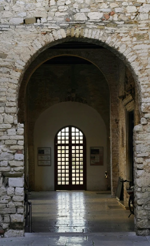 an open entryway with a brick wall and arched doorway