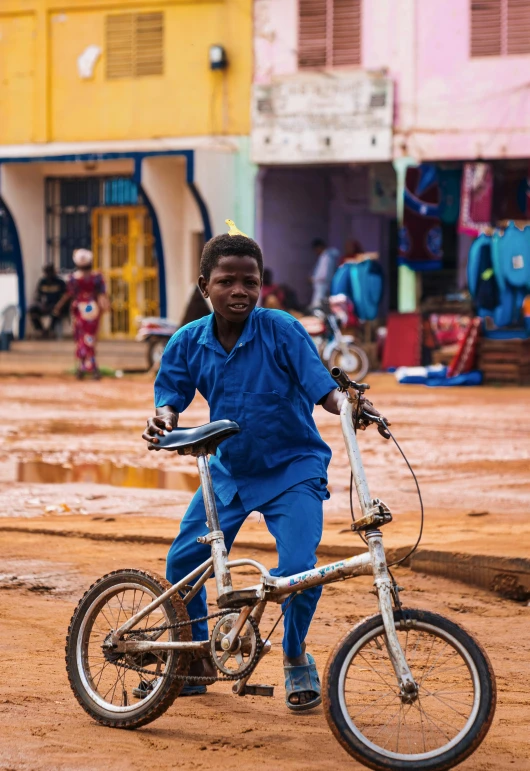 a man in blue pants on a bike