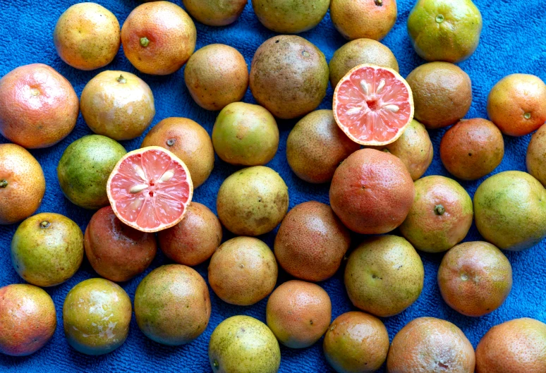 a close up view of oranges with a half cut in half