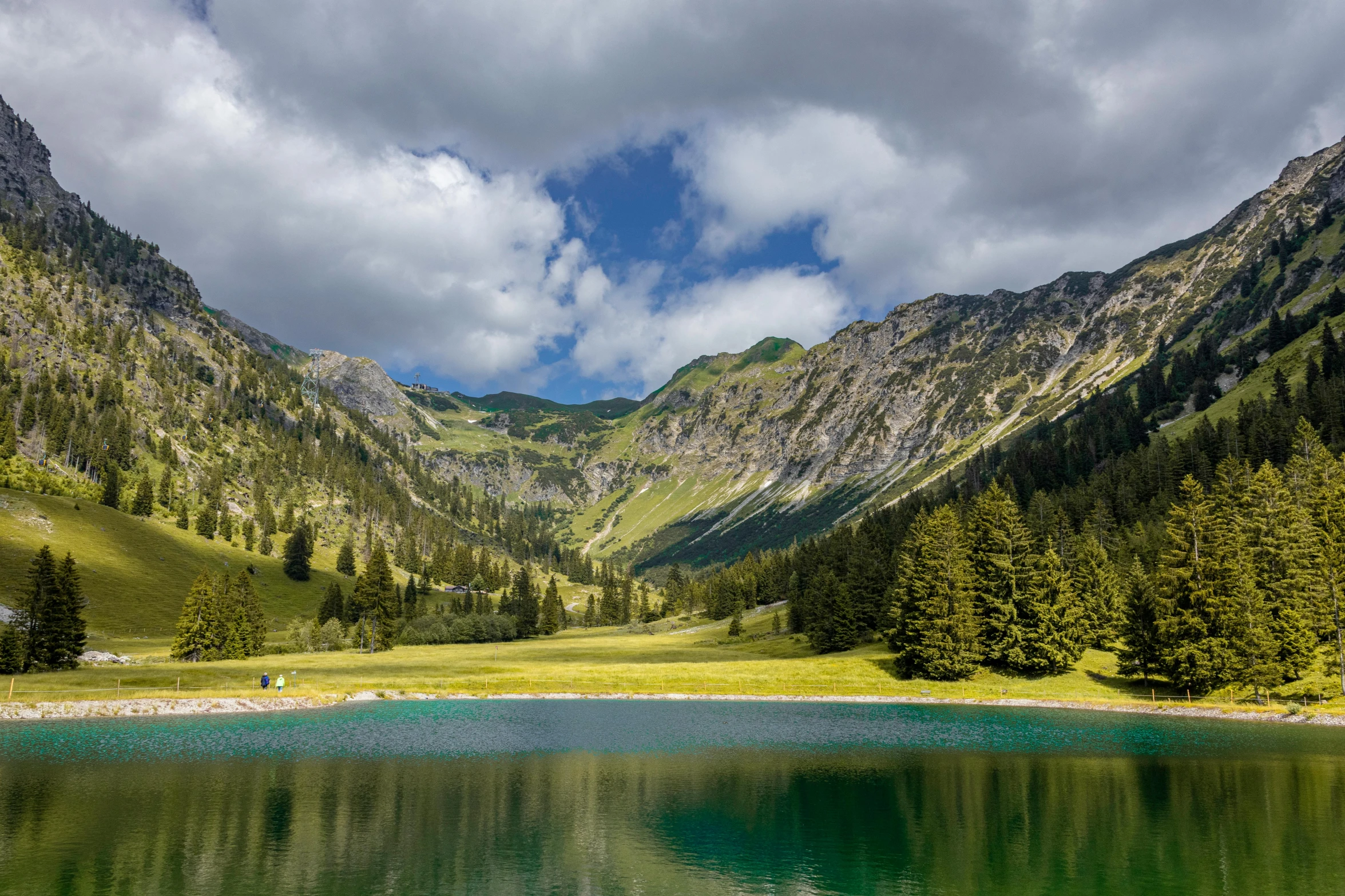 a beautiful mountain view on the side of a lake