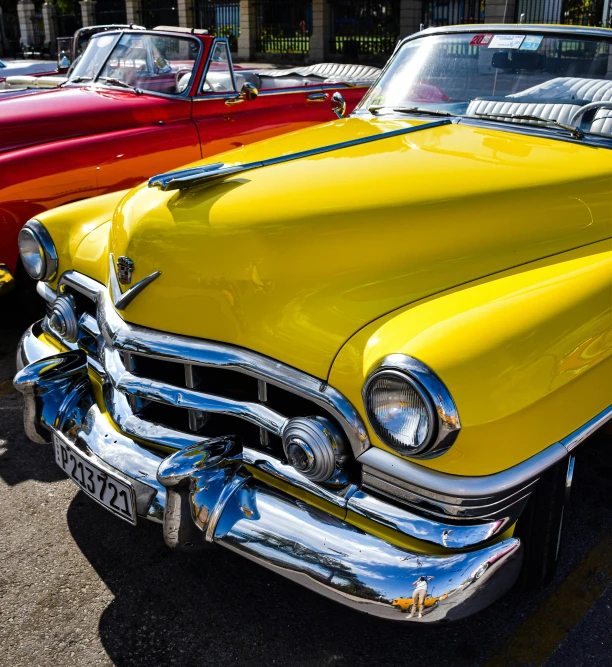 two classic cars parked next to each other