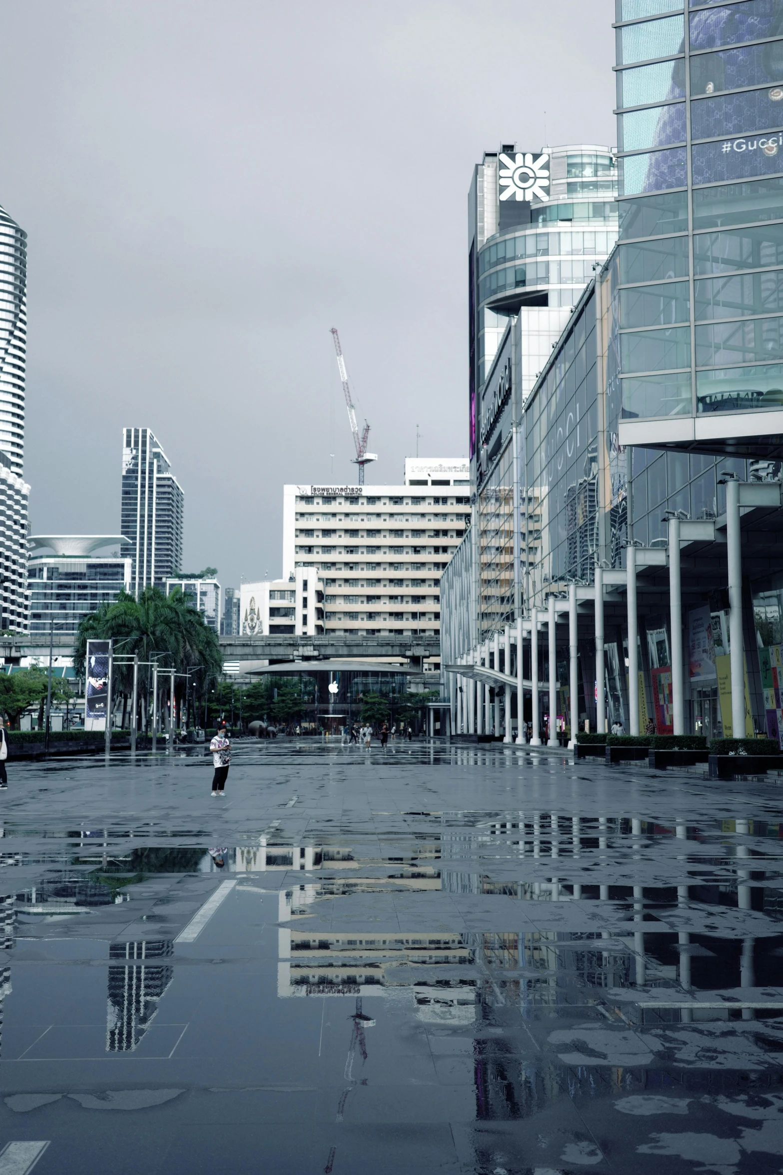 a view of the buildings from a street near a flooded road