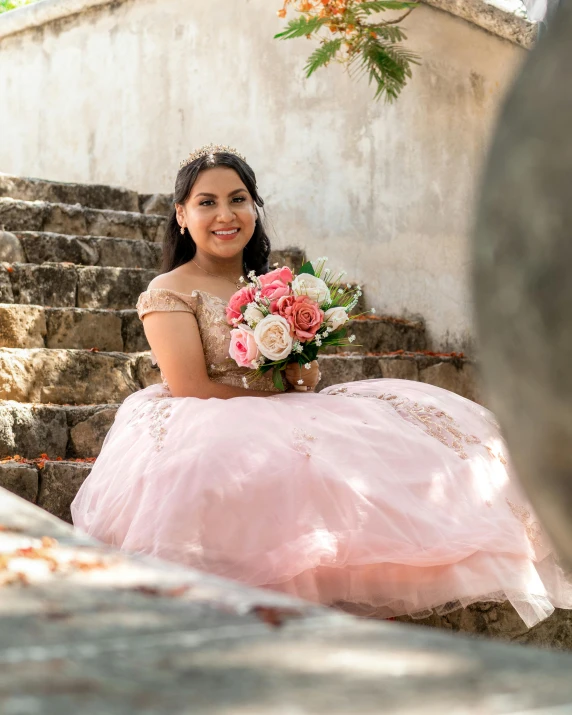 the girl in a pink dress has a pink and white bouquet