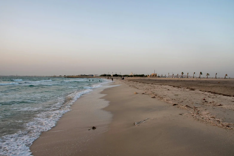 a beach with people on it and some waves