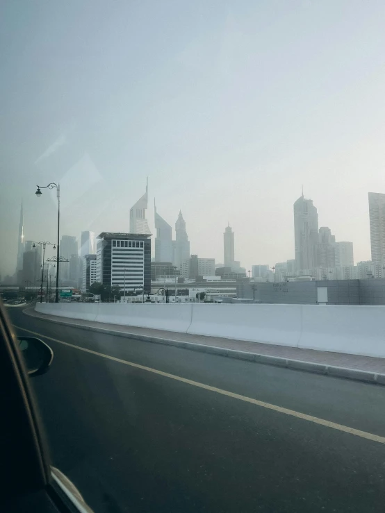 view of city from side of highway with car passing