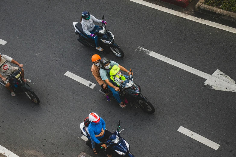 several people riding motorcycles on a road