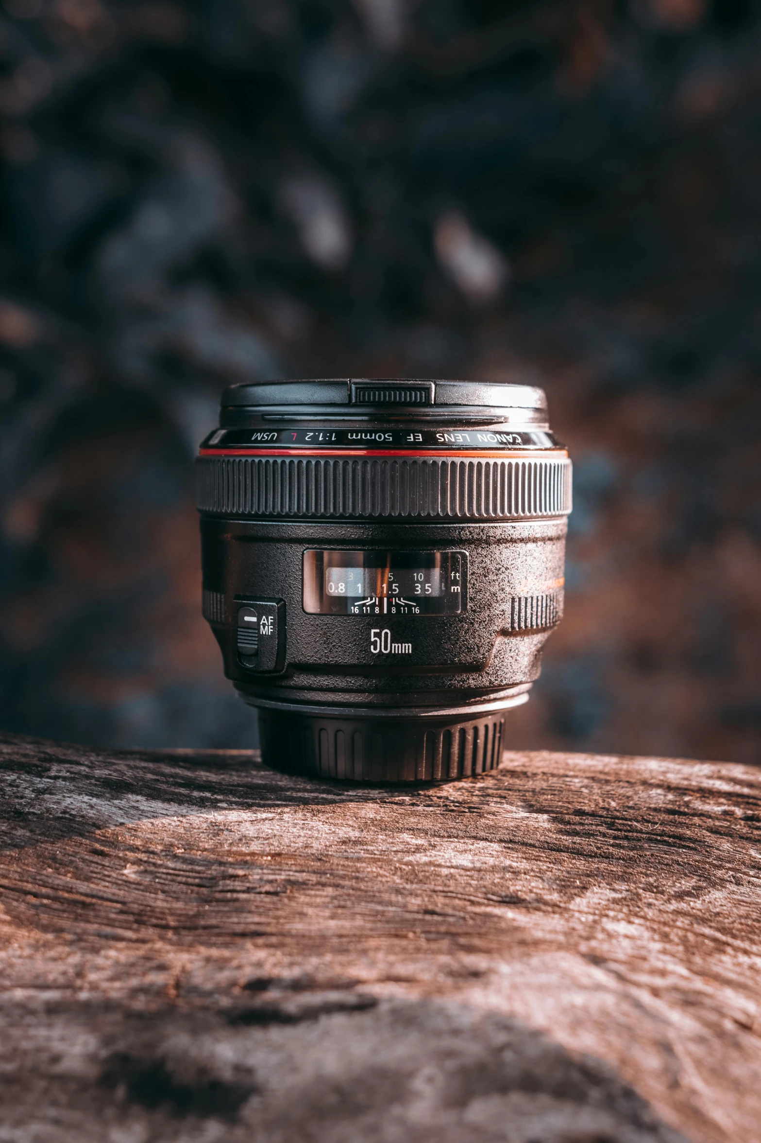 a camera lens sitting on top of a wooden surface