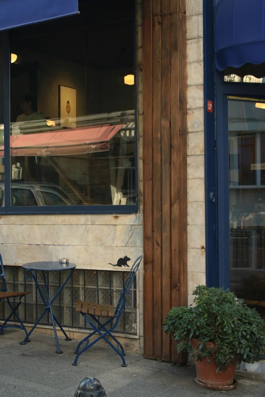 there is an outside cafe and table with chairs on it