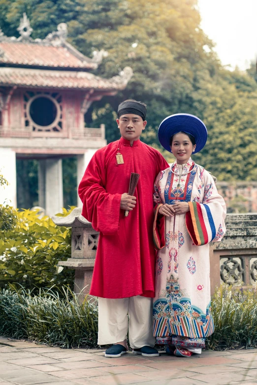 two people dressed in elaborate clothing standing together