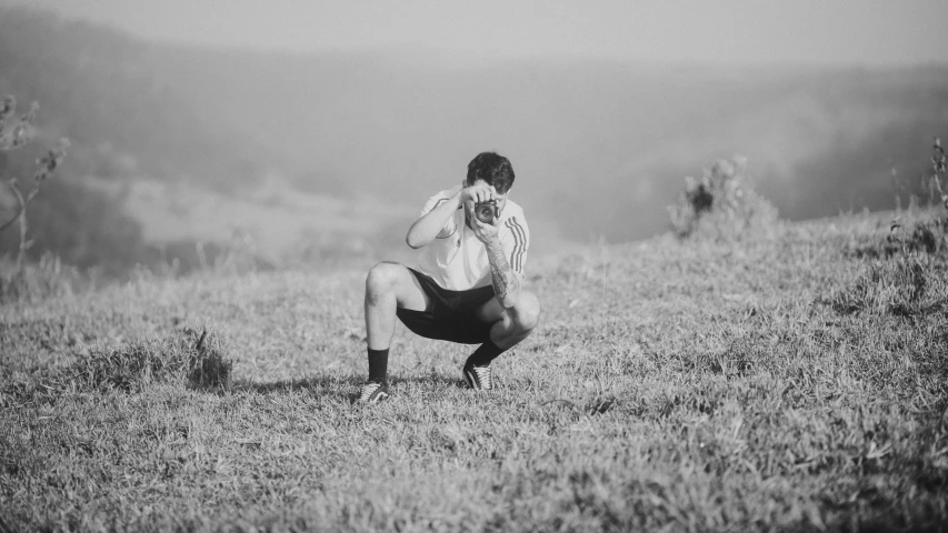 black and white pograph of a woman standing on a hill