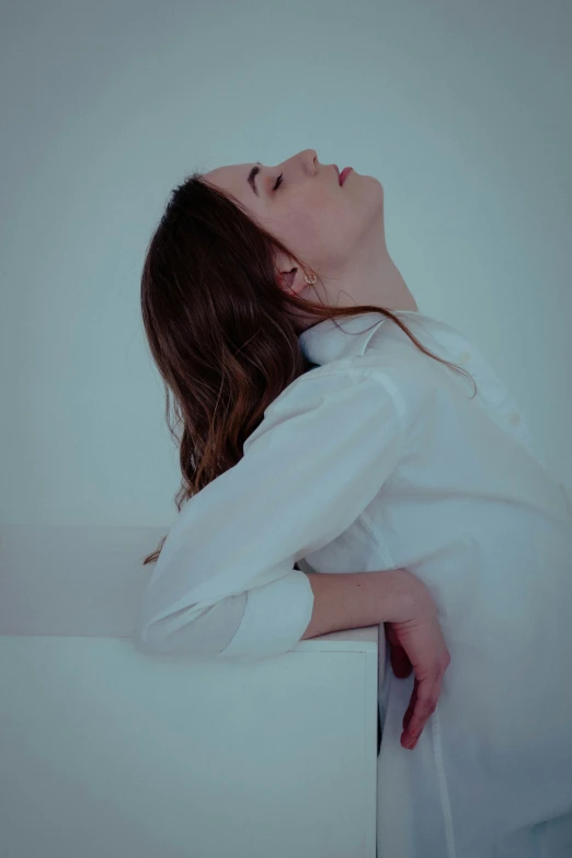 a beautiful young woman leaning on a wall and praying