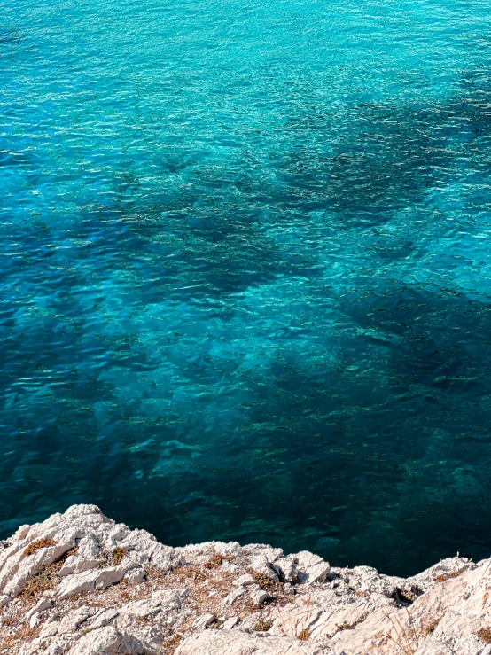 a lone white boat on the clear blue waters