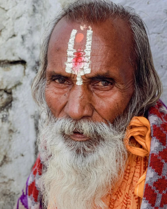 a man with white hair and facial paint on his face