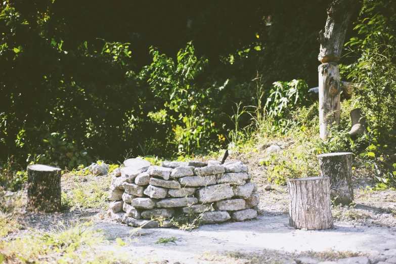 there are three stone structures and two wooden posts