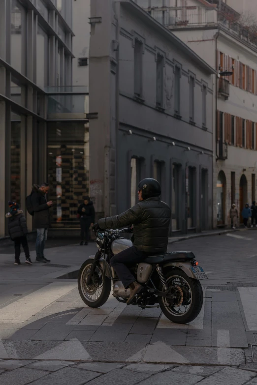 a man on a motorcycle is on the street