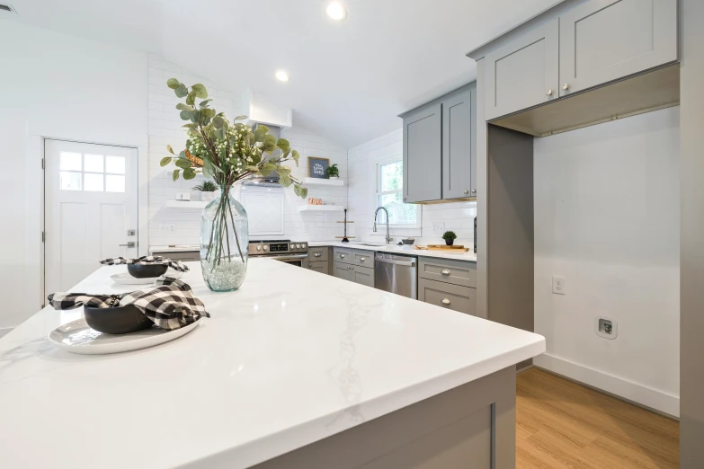 a modern style kitchen with counter top and stainless steel appliances