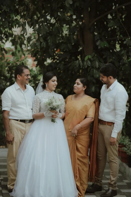 the bride and groom are standing by herself