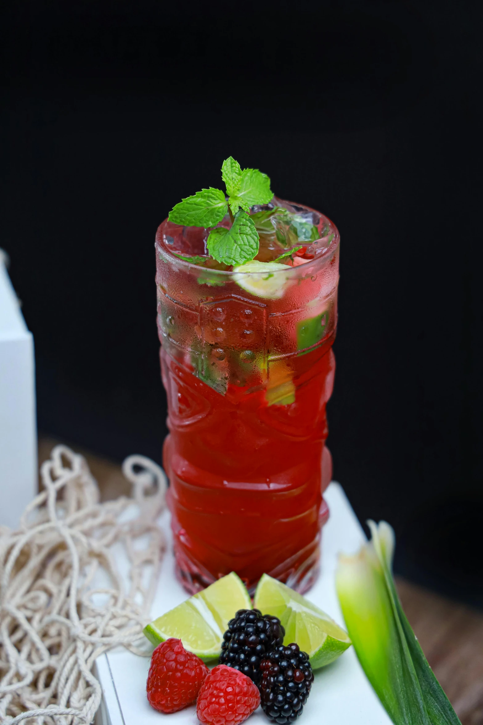 a fruit filled drink is placed on a white plate