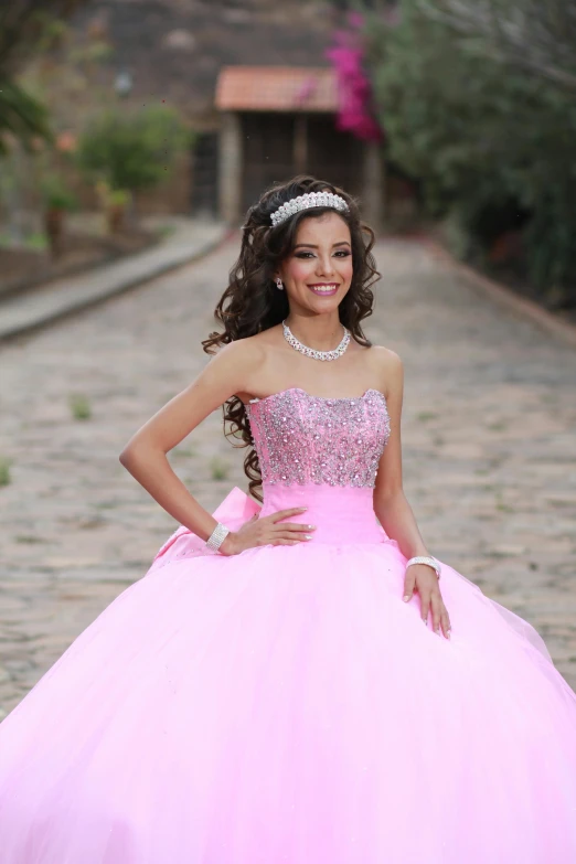 the  wears a pink ball gown with beads