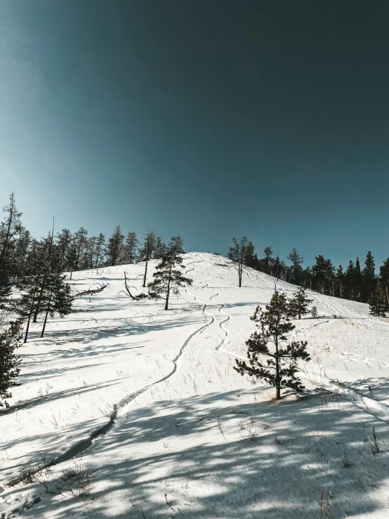 a mountain slope with snow on the top