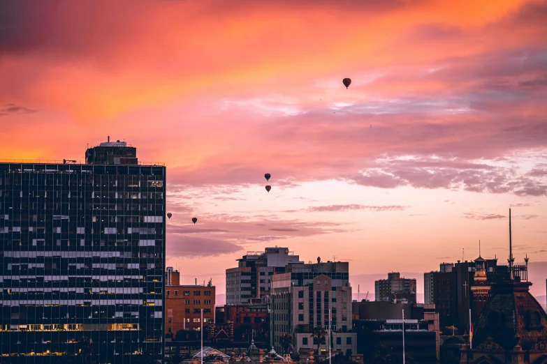 an overcast sky in a city with  air balloons