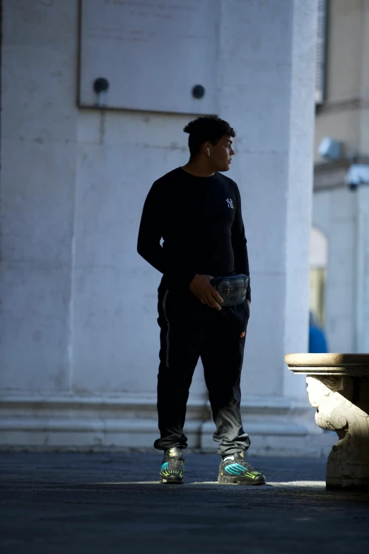 a man standing on a skateboard in front of some concrete